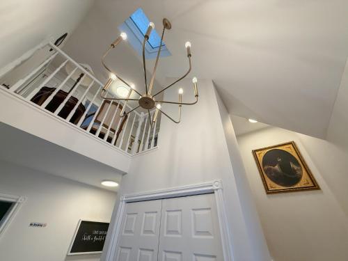 a chandelier hanging over a door in a hallway at The Promenade Cottage License # 002-2023 in Niagara-on-the-Lake