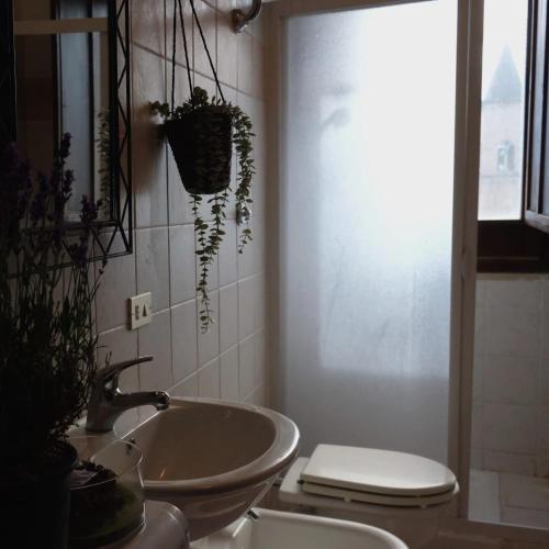 a bathroom with a sink and a toilet at Sotto le 3 Torri in Pacentro