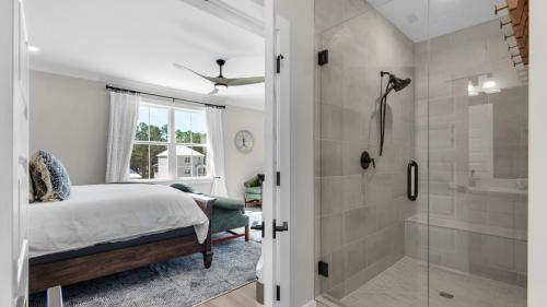 a bedroom with a shower and a bed and a bathroom at Harmony by the Bay in Santa Rosa Beach