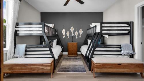 two bunk beds in a room with a bedroom at Harmony by the Bay in Santa Rosa Beach