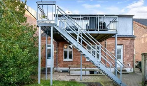 a house with a staircase on the side of it at Apartment in the center of Herning in Herning