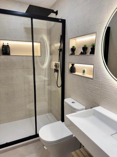 a bathroom with a shower and a toilet and a sink at Ap Fuenlabrada in Fuenlabrada