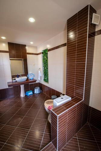 a bathroom with a toilet and a sink in it at Къща за гости Трявна in Tryavna