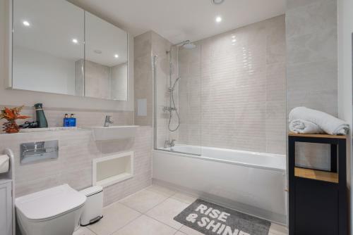 a bathroom with a tub and a toilet and a shower at The Oasis in Stonewood