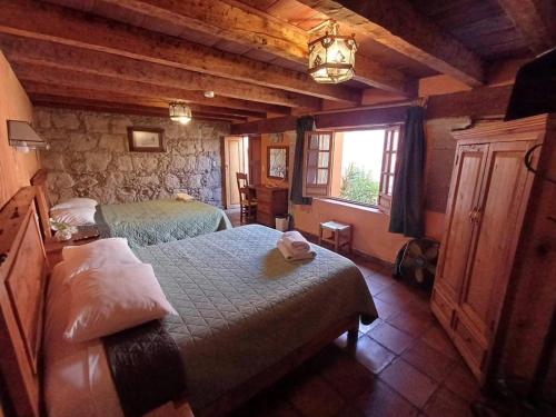 a bedroom with two beds and a window at Hotel Casa del Anticuario in Morelia