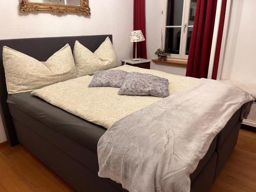 a bed with two pillows on it in a bedroom at Casa Restelli EG - nahe Andermatt Gotthard in Gurtnellen