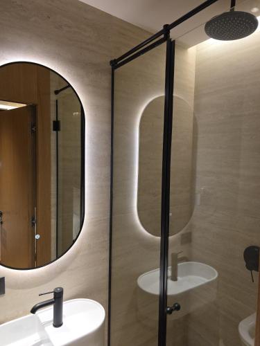 a bathroom with a sink and a mirror at Post Inn Hotel-New Bazaar in Tirana