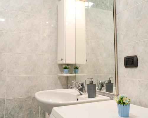 a bathroom with a sink and a mirror at Castello Living in Turin