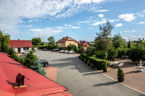 a view of a street with cars parked on the road at Karczma Pod Topolami in Ratowo Piotrowo