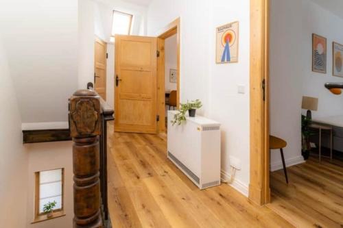 a room with a hallway with wooden floors and a door at Lykke Suite in Handewitt