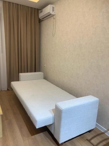 a hospital room with a bed and a air conditioner at E&L Apartment tbilisi in Tbilisi City