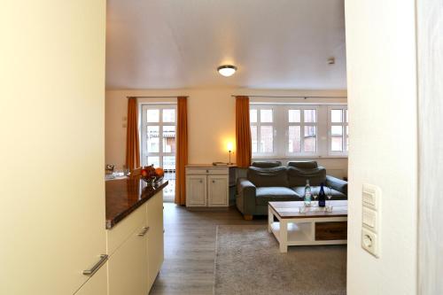 a living room with a couch and a table at Appartement 107 in Juist