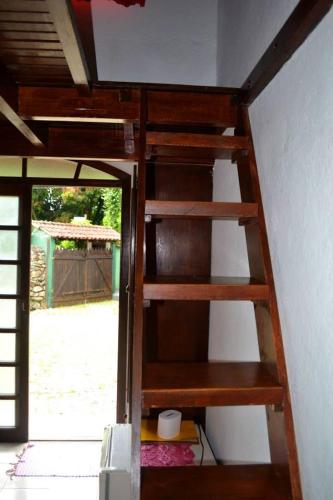 an open stairwell in a room with a ladder at Pousada Em Busca do Sol in Trindade