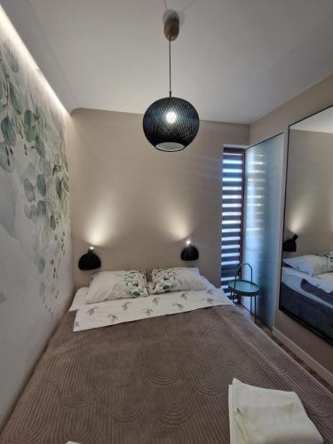 a bedroom with a large bed and a large mirror at Garden of Eden- MintGarden- Sveti Vlas in Sveti Vlas
