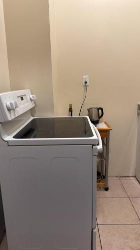 a kitchen with a sink and a stove at New York City Guesthouse 3 in New York