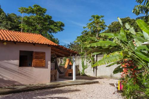 a small house with a hammock outside of it at Casa Rosaz in Cavalcante