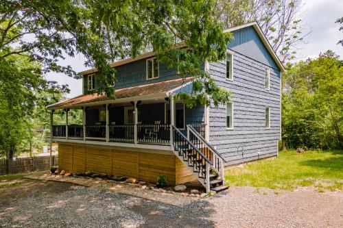 a house with a porch and stairs to the front of it at Blue Skies by Railey Vacations in Oakland