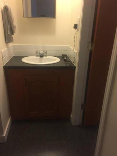 a bathroom with a sink and a mirror at Quiet-comfy 3 bedroom house on a tree lined street in Kitsilano in Vancouver