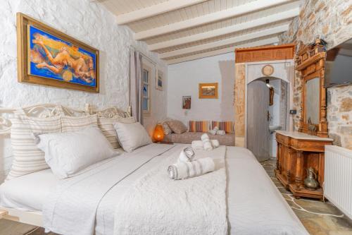 a bedroom with a large white bed in a room at Villa Art Natalie two in Kithnos