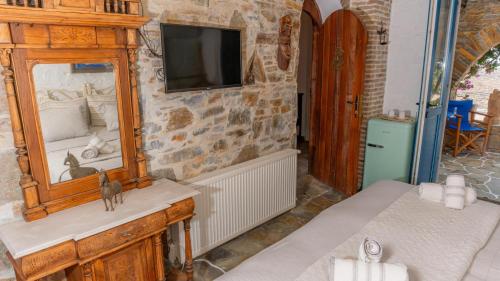 a room with a mirror and a tv on a wall at Villa Art Natalie two in Kithnos
