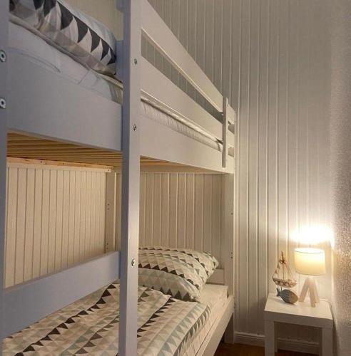 a bedroom with two bunk beds and a lamp at Kaept-ns-Inn in Burgtiefe auf Fehmarn 