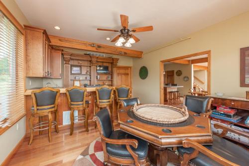 a living room with a table and chairs at Boulder Creek Lodge by Railey Vacations in McHenry