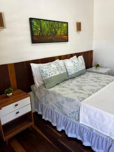 a bedroom with a bed and a night stand at suite elegante fullhausi 01 in Fortim