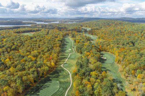 an aerial view of a golf course with fall trees at Bourbon Sunset by Railey Vacations in Swanton