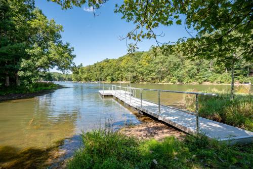 a dock in the middle of a river at Bracken Lodge by Railey Vacations in Swanton