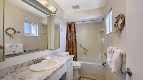 a bathroom with a sink and a toilet and a mirror at Crescent Royale Condominiums 515 in Siesta Key