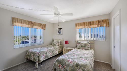 a bedroom with two beds and a ceiling fan at Crescent Royale Condominiums 515 in Siesta Key