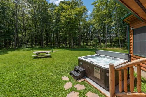 a hot tub in a yard next to a picnic table at Bucks Run by Railey Vacations in Oakland