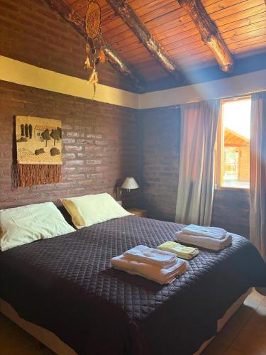 En eller flere senge i et værelse på Cabañas Atrapasueños