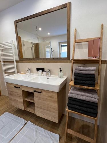 a bathroom with a sink and a large mirror at Haus Steinplatte in Waidring