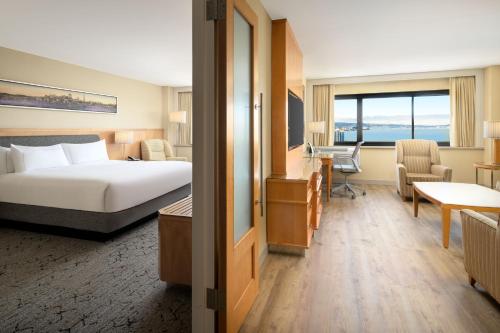 a hotel room with a bed and a desk at Hilton San Francisco Airport Bayfront - No Resort Fee in Burlingame