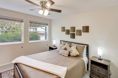a bedroom with a bed and a ceiling fan at Private Beach, Deck & Grill! Siuslaw River Getaway in Florence