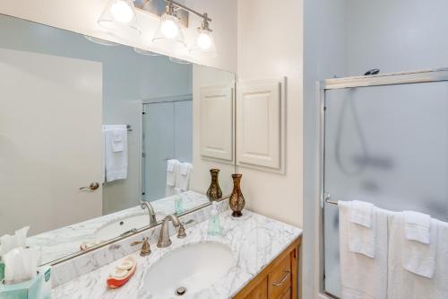 a bathroom with a sink and a mirror at Private Beach, Deck & Grill! Siuslaw River Getaway in Florence