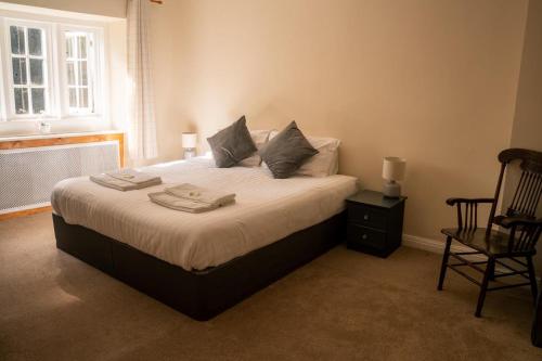 a bedroom with a bed with two towels on it at The George Inn in Tideswell