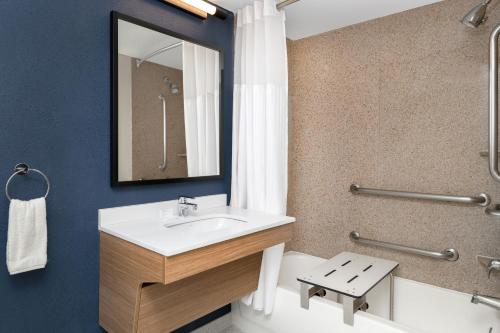 a bathroom with a sink and a toilet and a mirror at Spark by Hilton Murfreesboro in Murfreesboro