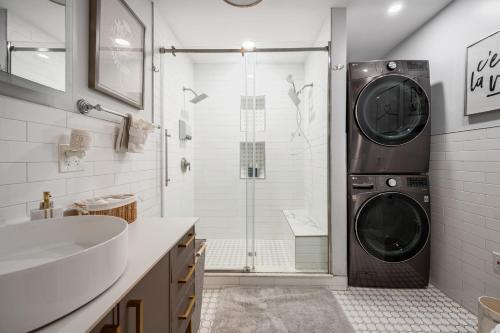 a bathroom with a shower and a washing machine at Charming Boston Retreat 3BR Parking Perfect for Families & Groups in Revere