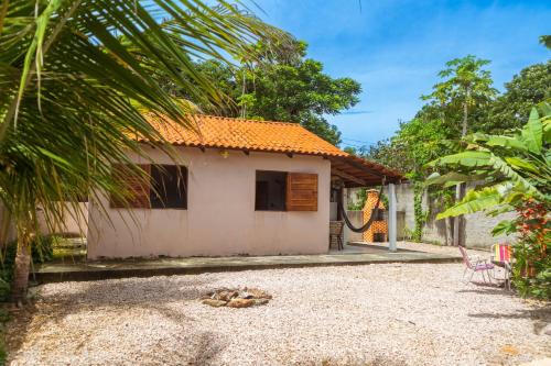 a house with a hammock in front of it at Casa Rosaz in Cavalcante