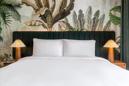 a bedroom with a bed and a wall with plants at Yas Plaza Mangroves by IHG in Abu Dhabi