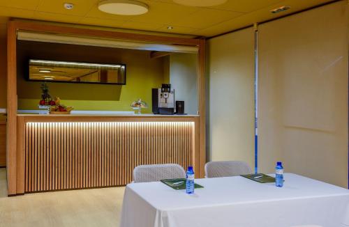 a table with two bottles of water on top of it at Hotel Sercotel Plana Onda in Onda