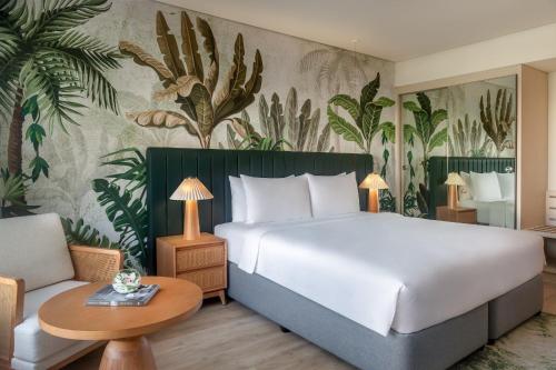 a hotel room with a bed and a couch at Yas Plaza Mangroves by IHG in Abu Dhabi
