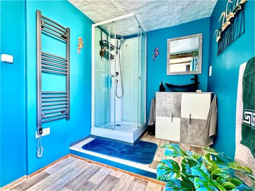 a bathroom with a shower with blue walls at Casa Alba in Mastershausen
