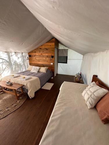 a bedroom with two beds in a tent at moraycamp in San Andrés de Giles