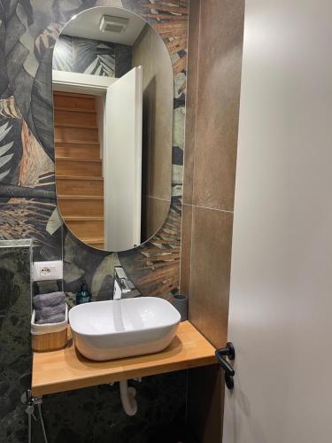 a bathroom with a sink and a mirror at Liams Cozy Villa in Korçë