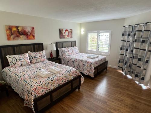 a bedroom with two beds and a window at 15 - Amazing Vulcano Bay - Universal View in Orlando