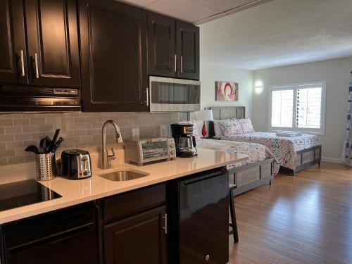 a kitchen with a counter top and a living room at 15 - Amazing Vulcano Bay - Universal View in Orlando