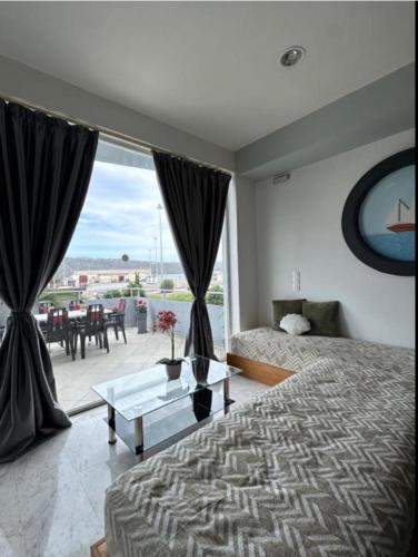 a bedroom with a bed and a view of a patio at Nova Marine in Souda